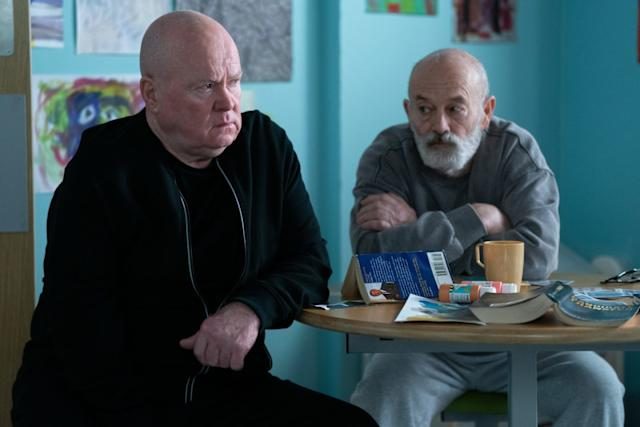 two men sitting at a table